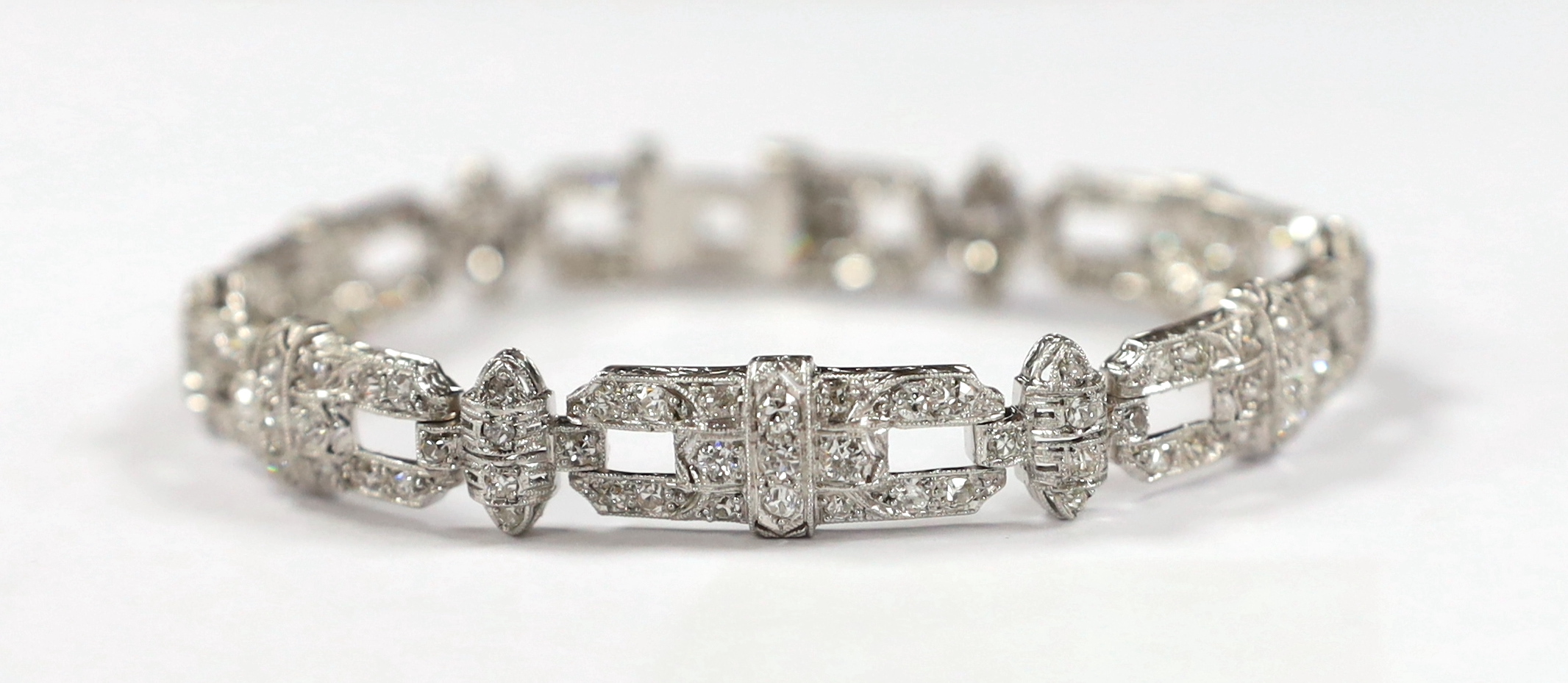 An Art Deco style pierced platinum and diamond cluster set bracelet